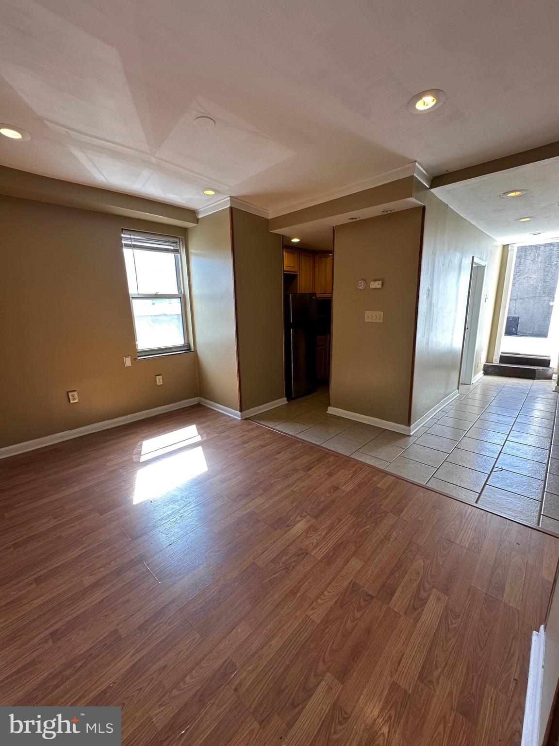 1846 South 12th Street, Unit 2 Philadelphia, PA 19148 - Photo 4 of 18 an empty room with wooden floor and windows