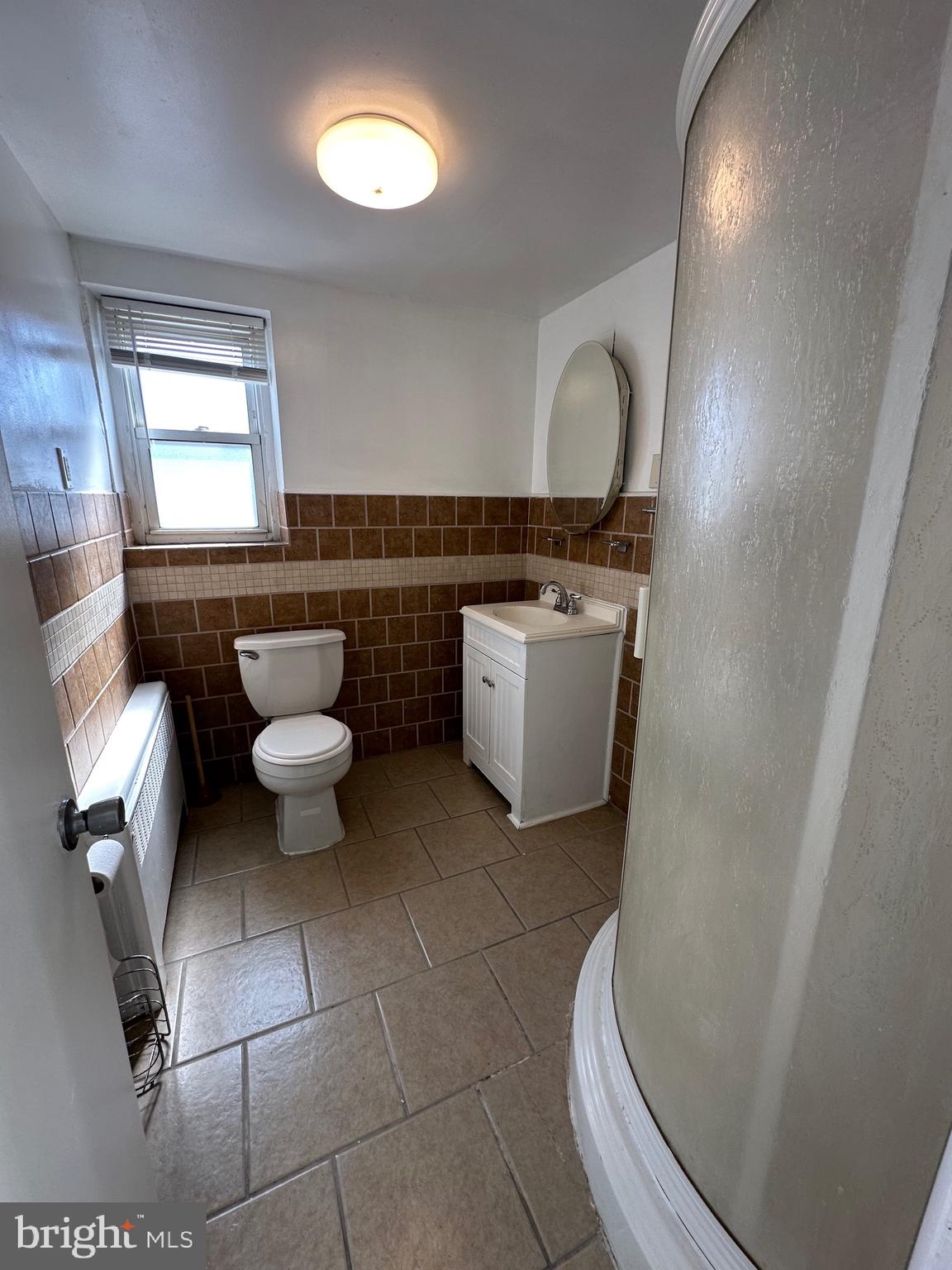 1846 South 12th Street, Unit 2 Philadelphia, PA 19148 - Photo 5 of 18 a bathroom with a toilet sink and mirror