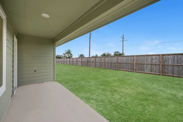 a view of a backyard with grass