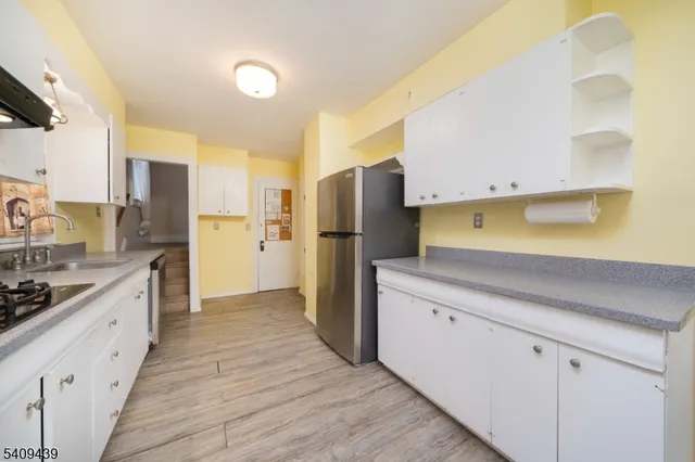 a kitchen with a refrigerator and a sink