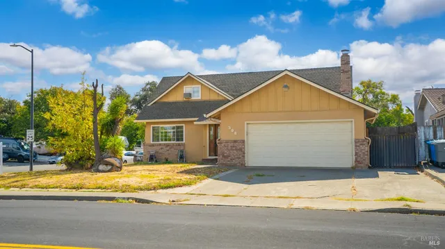 a front view of a house with a yard and garage