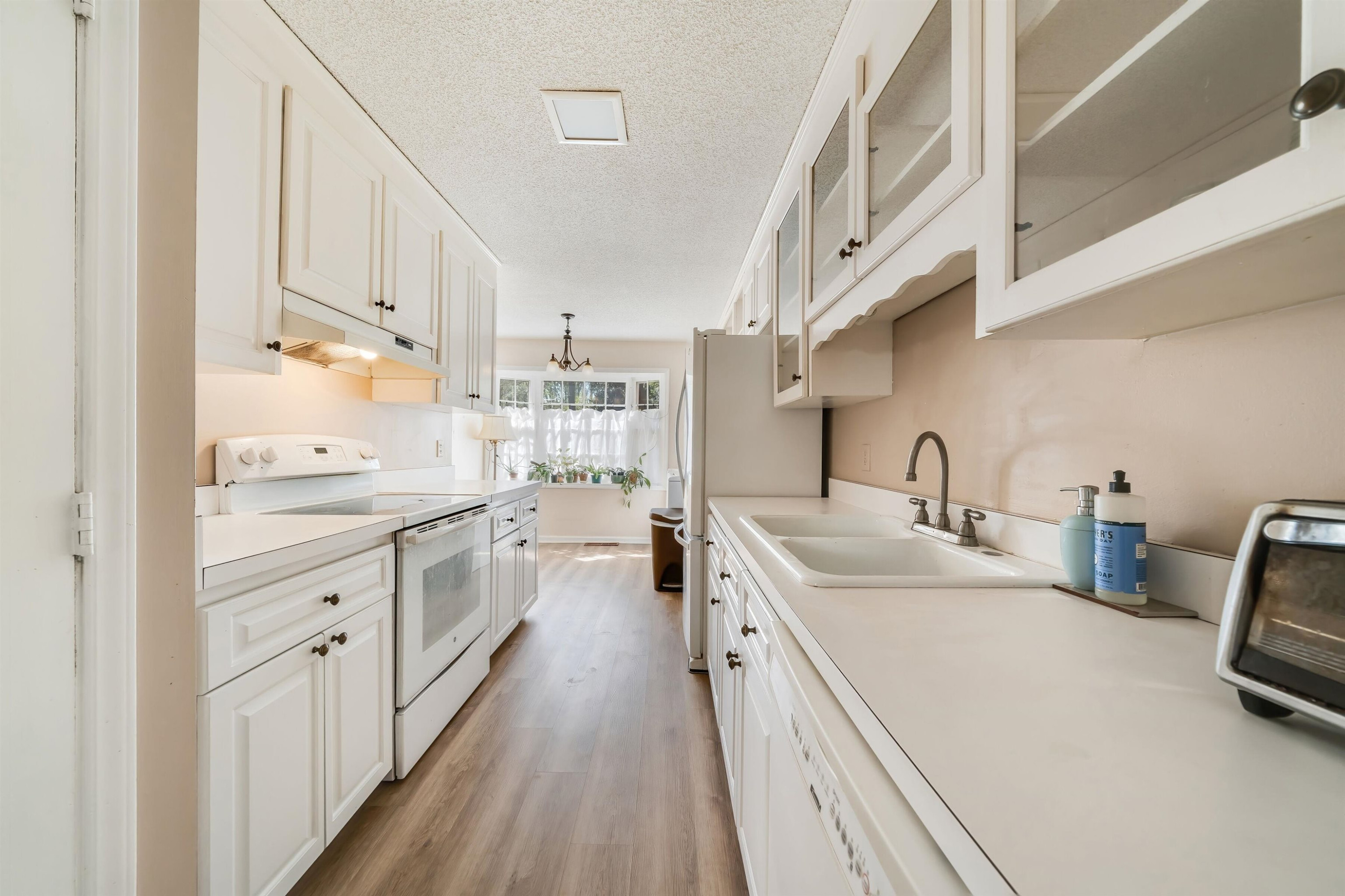 2890 Wycliff Road Raleigh, NC 27607 - Photo 8 of 16 Galley Kitchen with White Cabinets