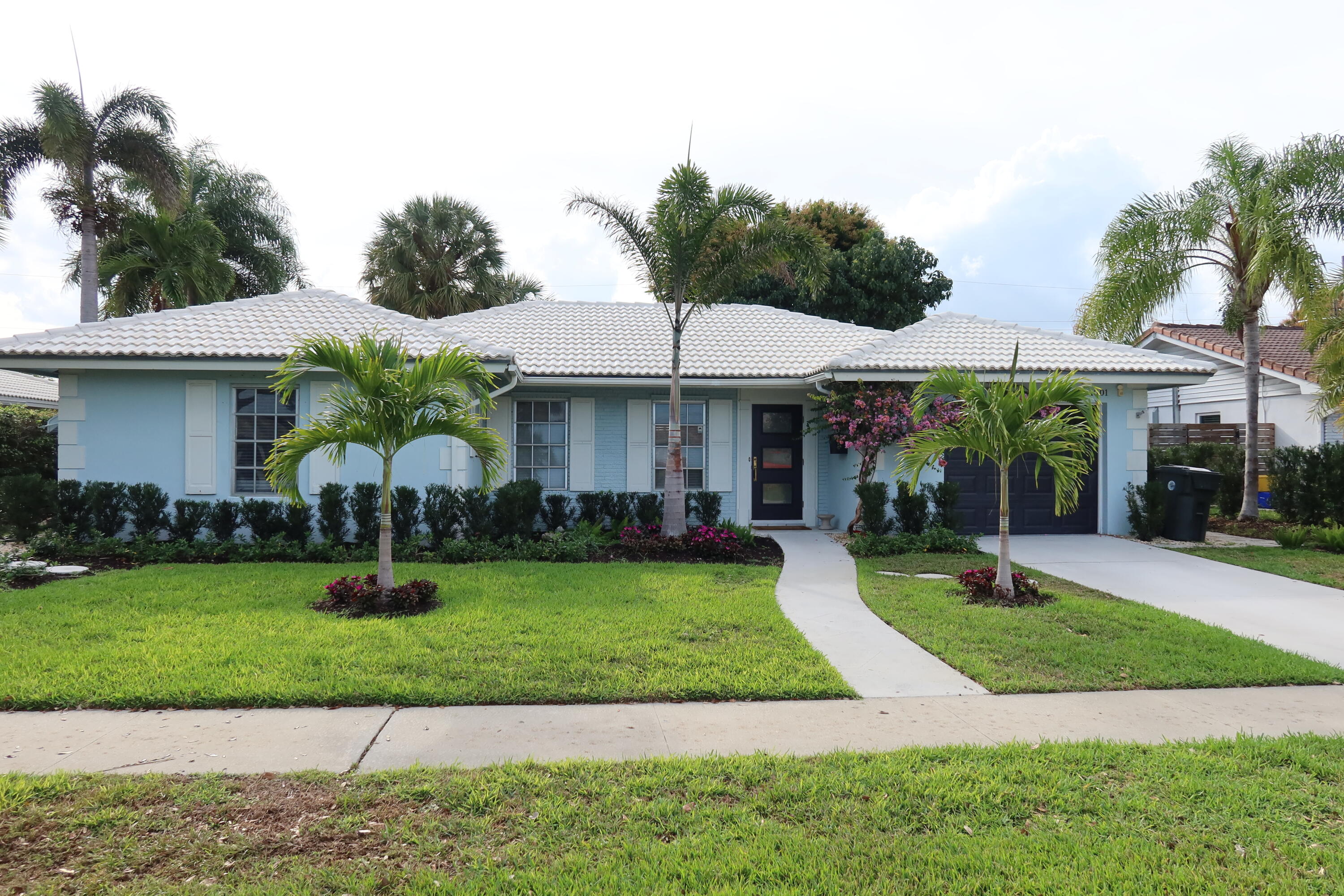 a front view of a house with garden and porch