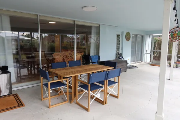 a dining room with furniture and wooden floor