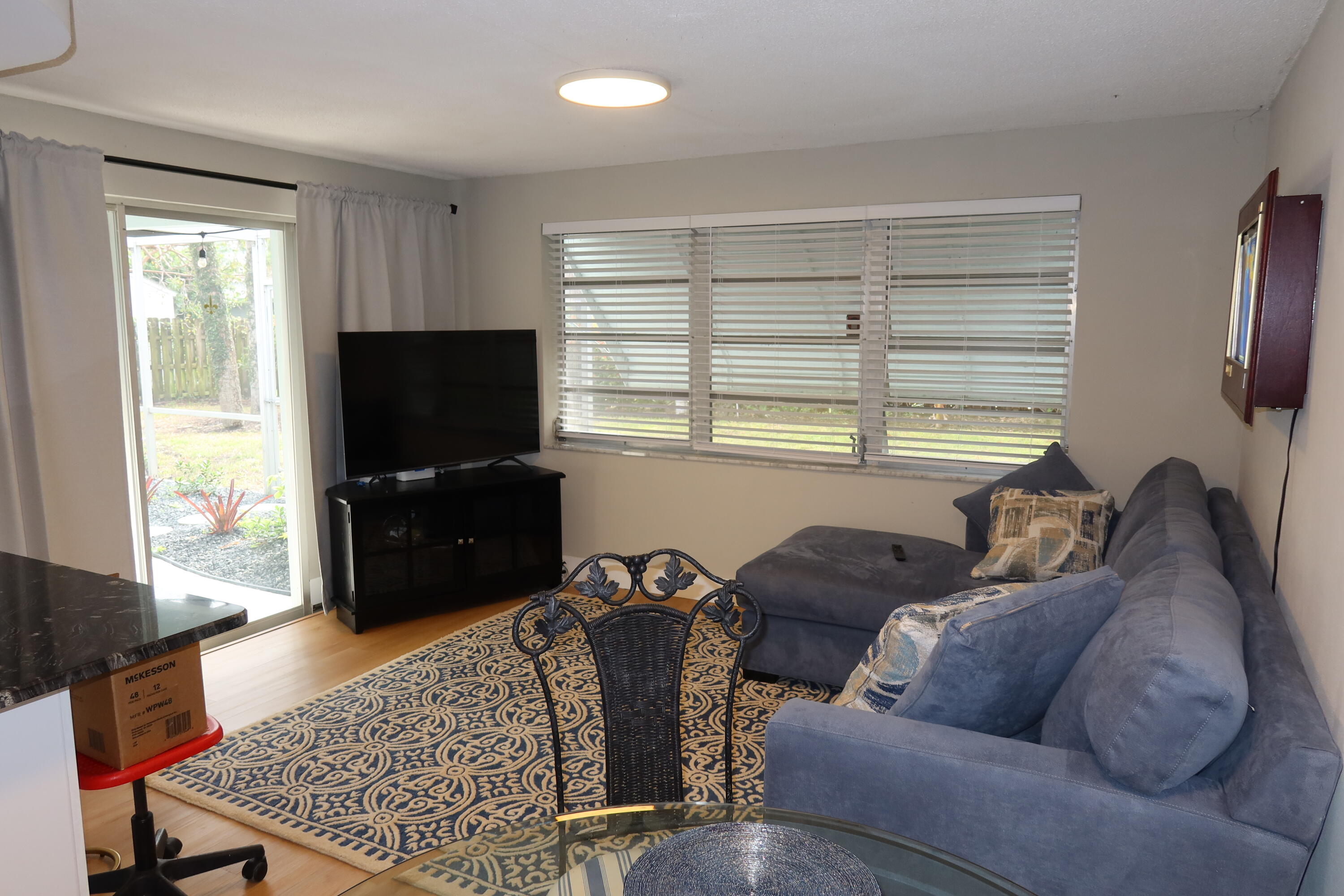 1001 Southwest 12th Terrace Boca Raton, FL 33486 - Photo 13 of 13 a living room with furniture a flat screen tv and a window
