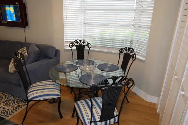 a dining room with furniture and wooden floor