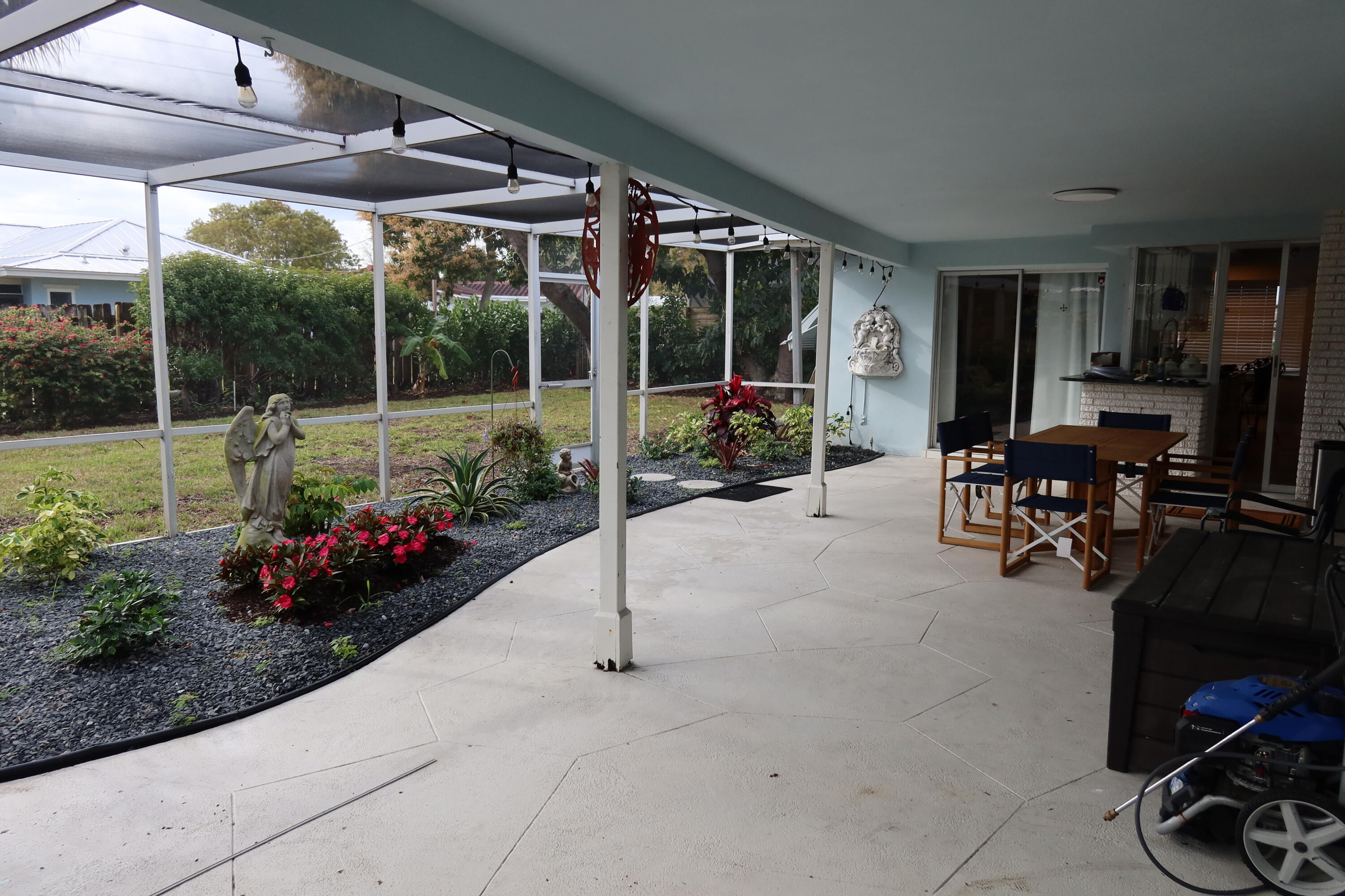 1001 Southwest 12th Terrace Boca Raton, FL 33486 - Photo 10 of 13 a view of a patio with table and chairs potted plants and floor to ceiling window