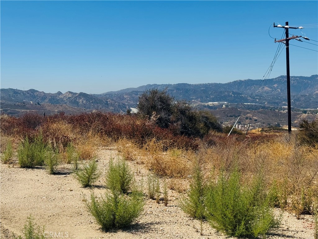 0 Mad Newhall, CA 91321 - Photo 2 of 8 Beautiful panoramic view of the property with scenic mountain views.
* Slot 2: View overlooking the surrounding hills and natural landscape.
* Slot 3: Open terrain showcasing the property's natural setting.
* Slot 4: Wide view highlighting the property's open space and mountain backdrop.
* Slot 5: Panoramic view of the surrounding desert landscape.
* Slot 6: Ground-level view of the property.
* Slot 7: Additional panoramic view of the surrounding area.
* Slot 8: View of the property and surroundin...