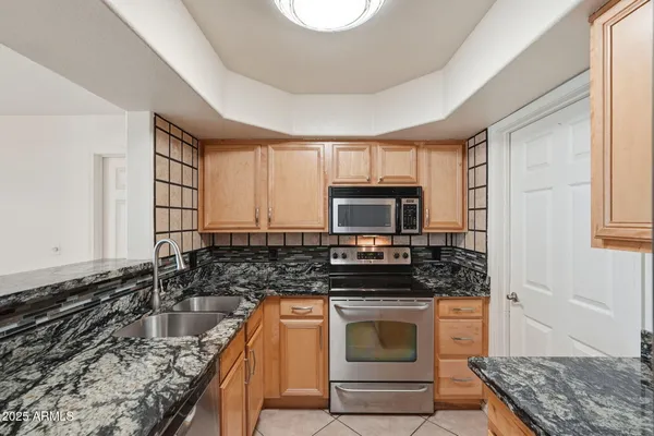 a view of an empty room with a kitchen