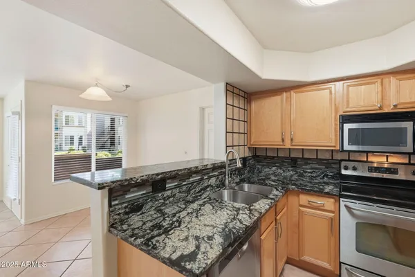 a view of a kitchen with a sink and a microwave