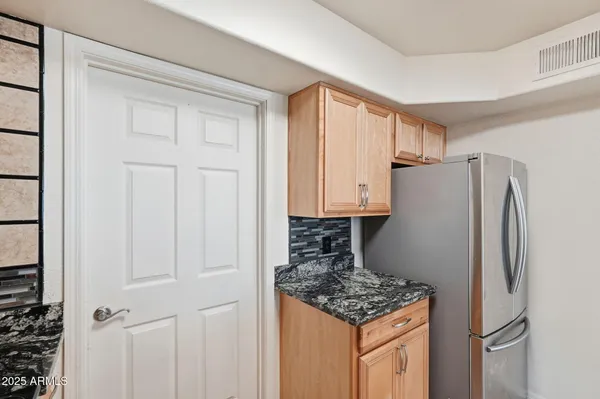 a kitchen with granite countertop a stove a sink and a microwave