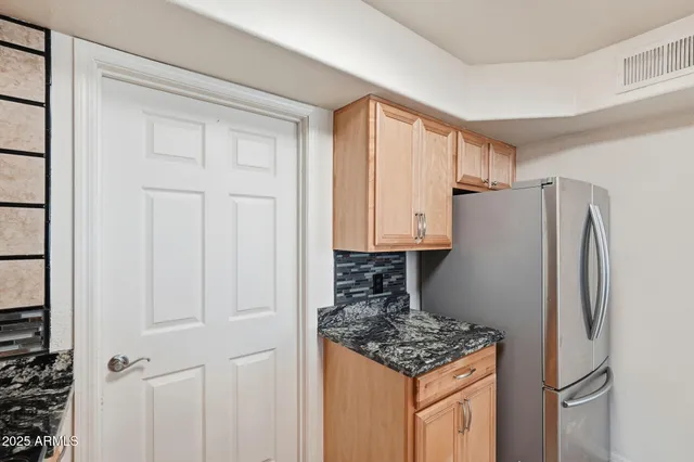 a kitchen with granite countertop a stove a sink and a microwave