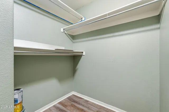 an empty room with closet and windows