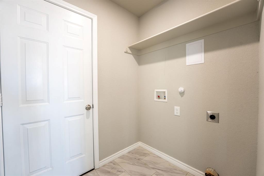 1032 Springview Lane Mabank, TX 75147 - Photo 12 of 15 Laundry room with gas dryer hookup, light marble finish floors, hookup for a washing machine, and hookup for an electric dryer