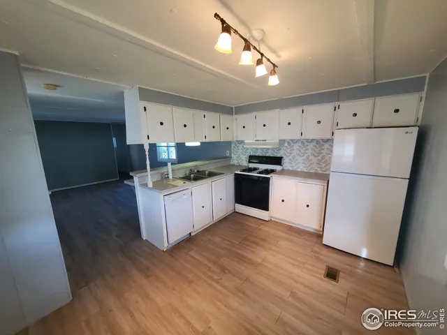 a kitchen with stainless steel appliances granite countertop a refrigerator a sink and a stove