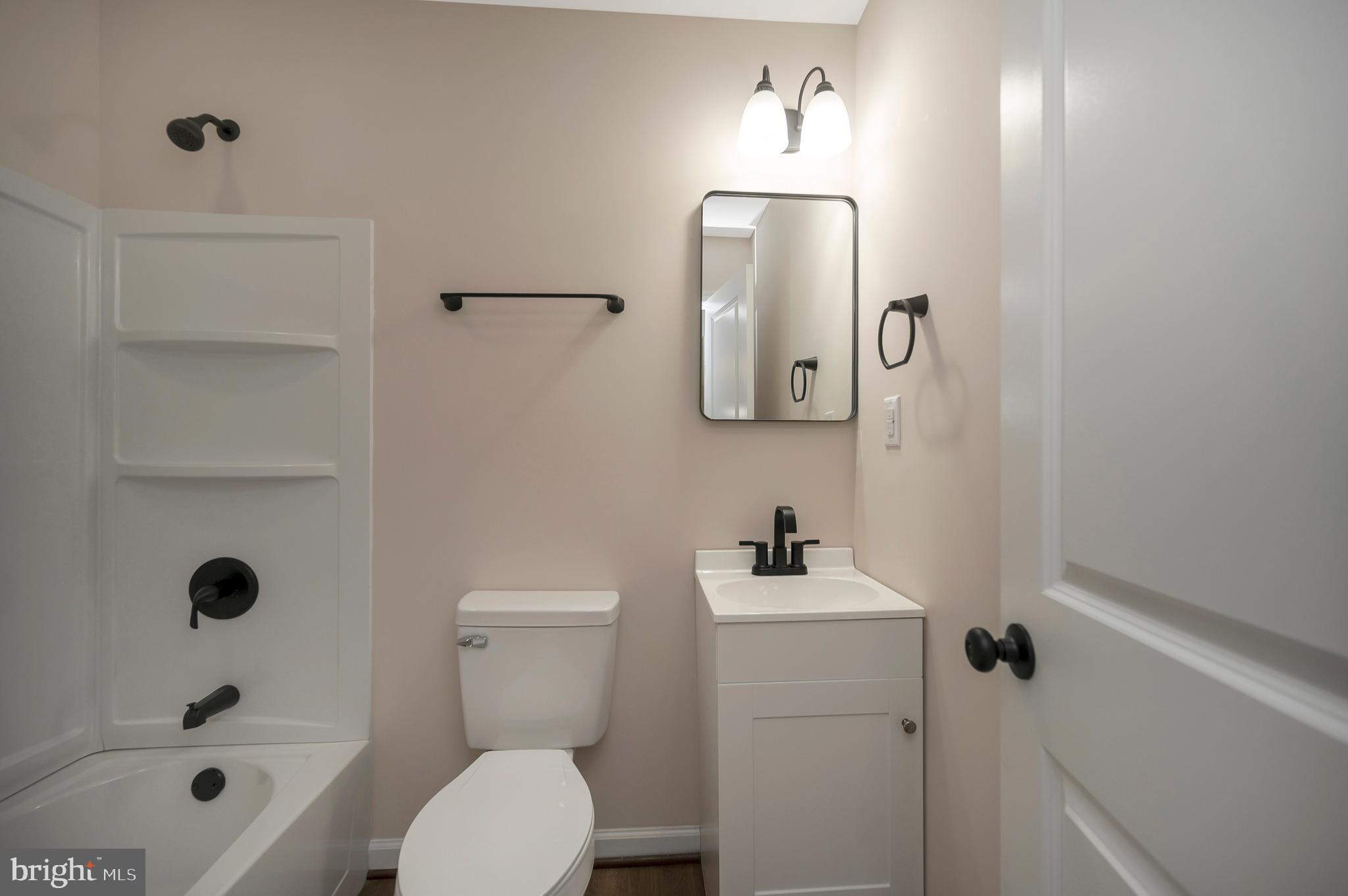 14169 Silver Hill Road Sumerduck, VA 22742 - Photo 20 of 40 a bathroom with a sink a toilet and shower