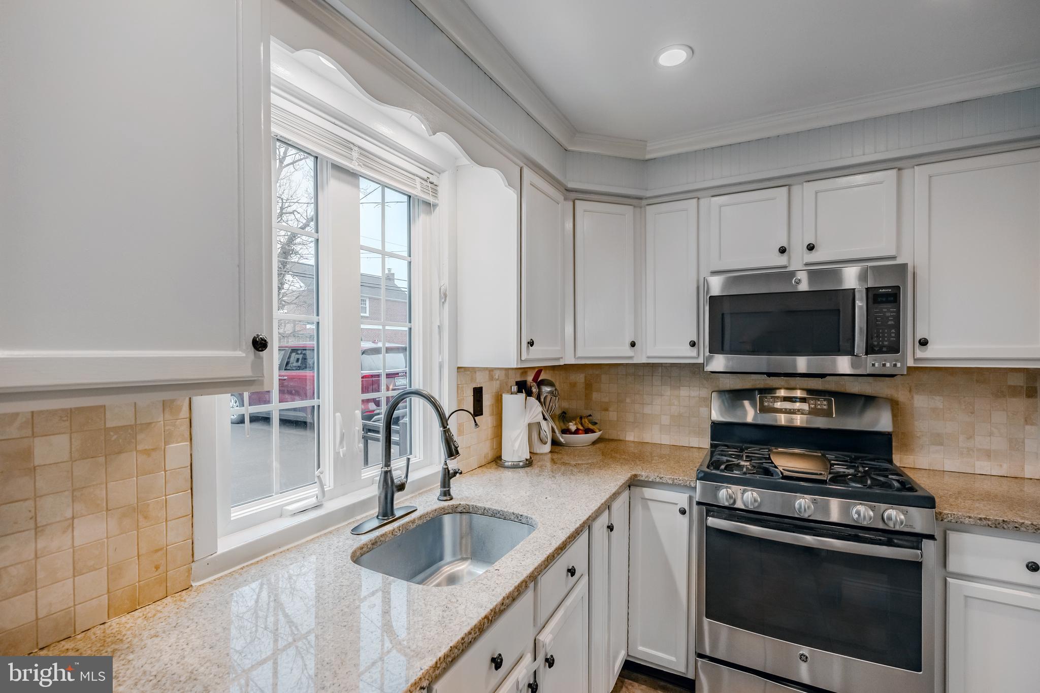 216 Earlington Road Havertown, PA 19083 - Photo 11 of 26 a kitchen with granite countertop a sink stainless steel appliances and cabinets
