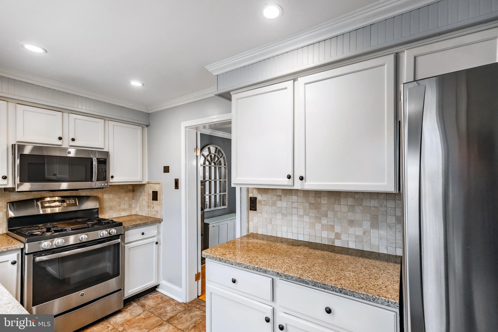 216 Earlington Road Havertown, PA 19083 - Photo 12 of 26 a kitchen with granite countertop a refrigerator stove and microwave