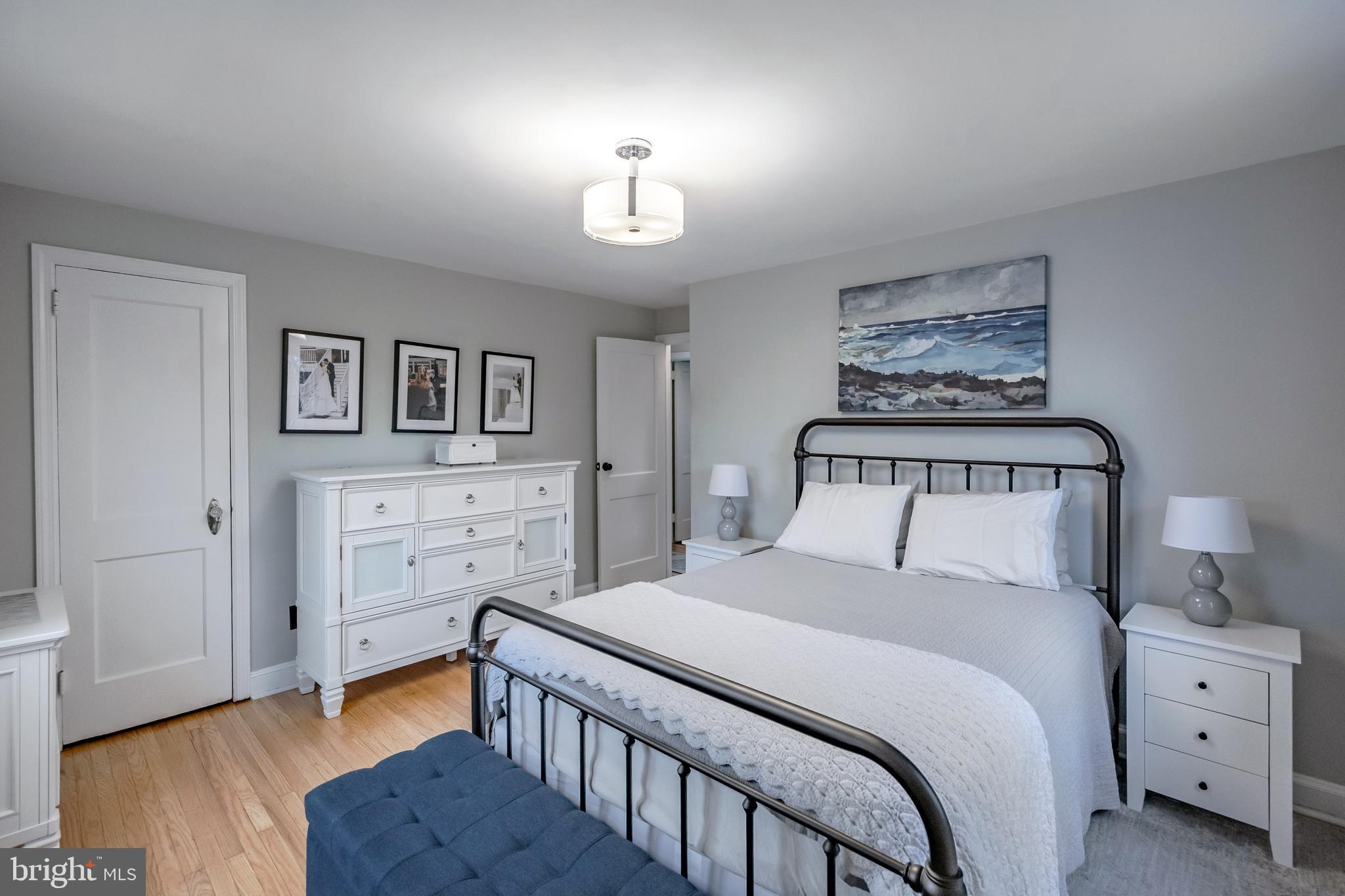 216 Earlington Road Havertown, PA 19083 - Photo 15 of 26 a bedroom with a bed and a lamp on dresser