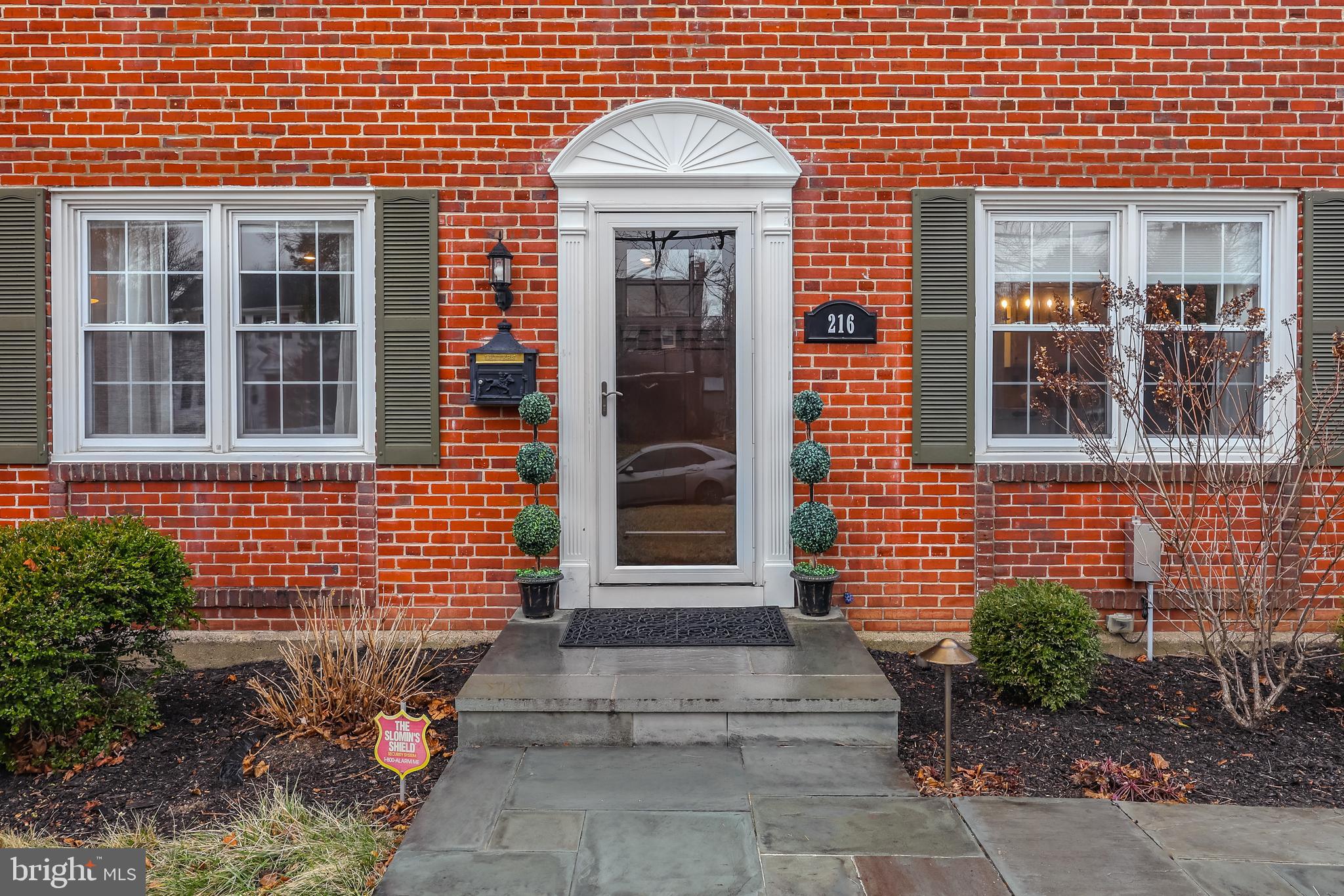 216 Earlington Road Havertown, PA 19083 - Photo 2 of 26 a front view of a house with a garden