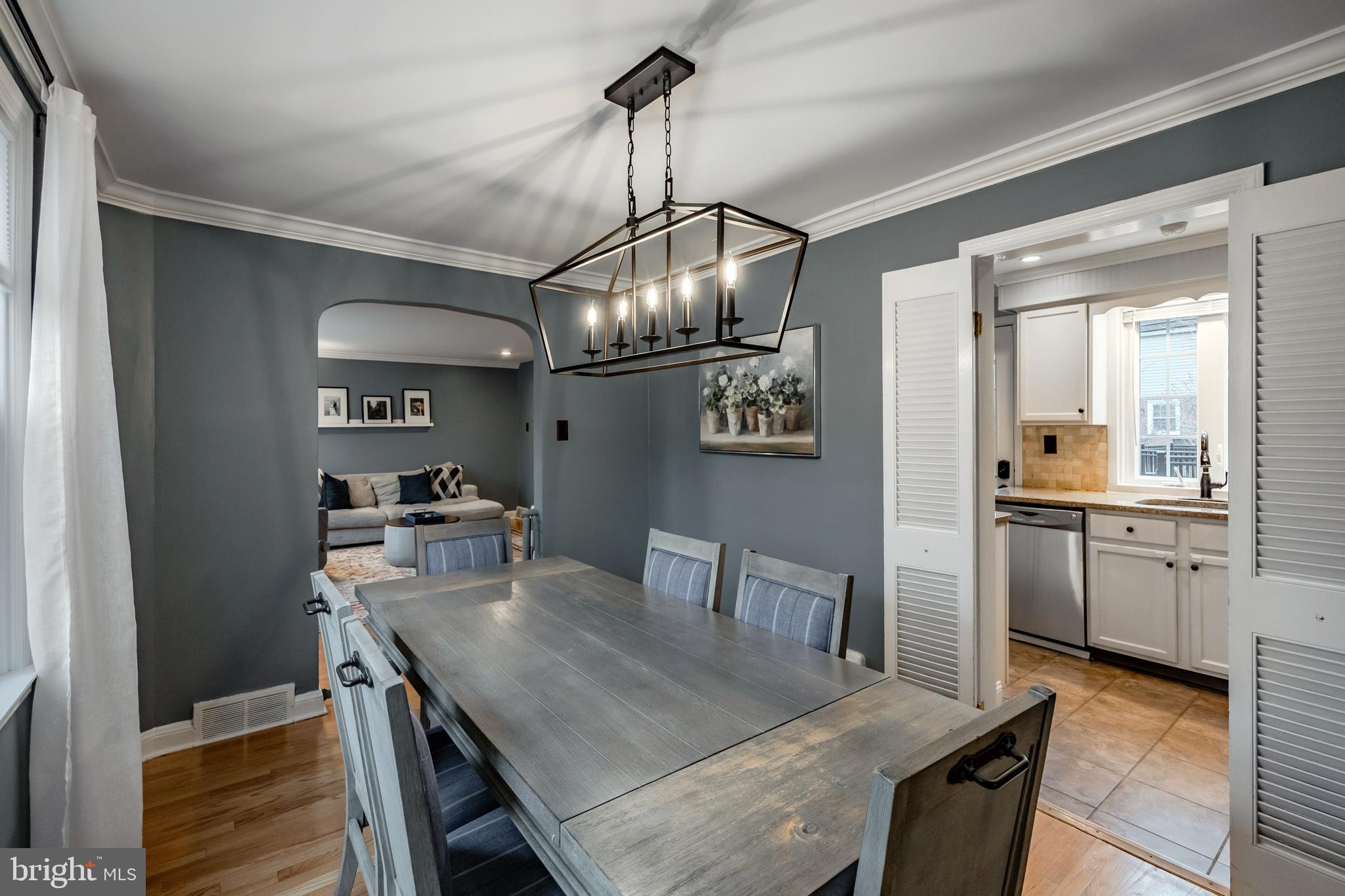 216 Earlington Road Havertown, PA 19083 - Photo 8 of 26 a dining room with furniture a chandelier and wooden floor