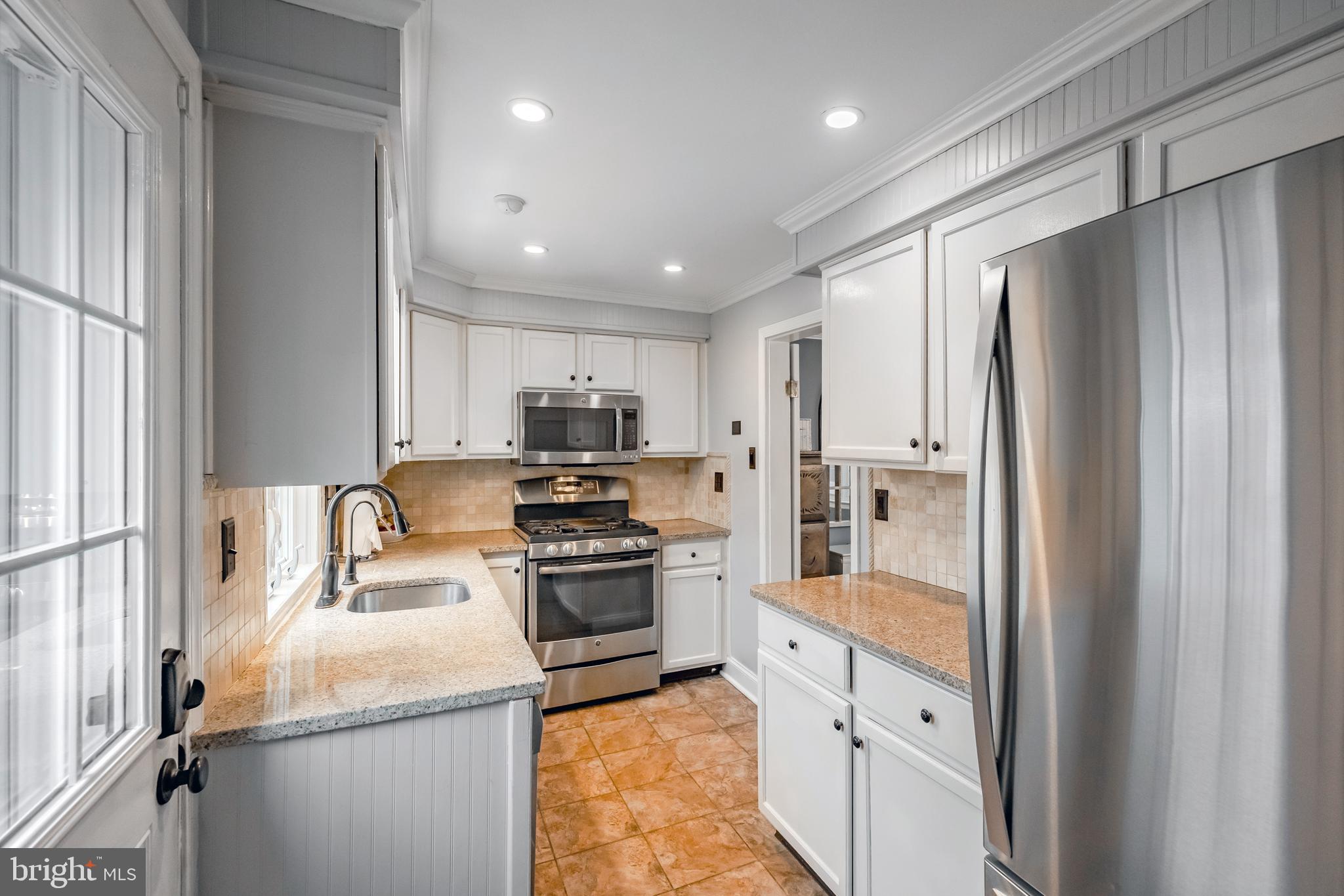 216 Earlington Road Havertown, PA 19083 - Photo 9 of 26 a kitchen with stainless steel appliances granite countertop a refrigerator and a stove top oven