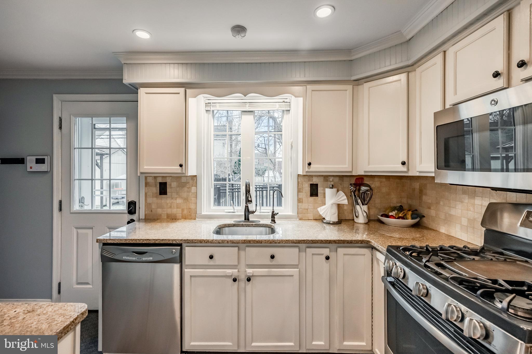 216 Earlington Road Havertown, PA 19083 - Photo 10 of 26 a kitchen with stainless steel appliances granite countertop a sink stove and cabinets