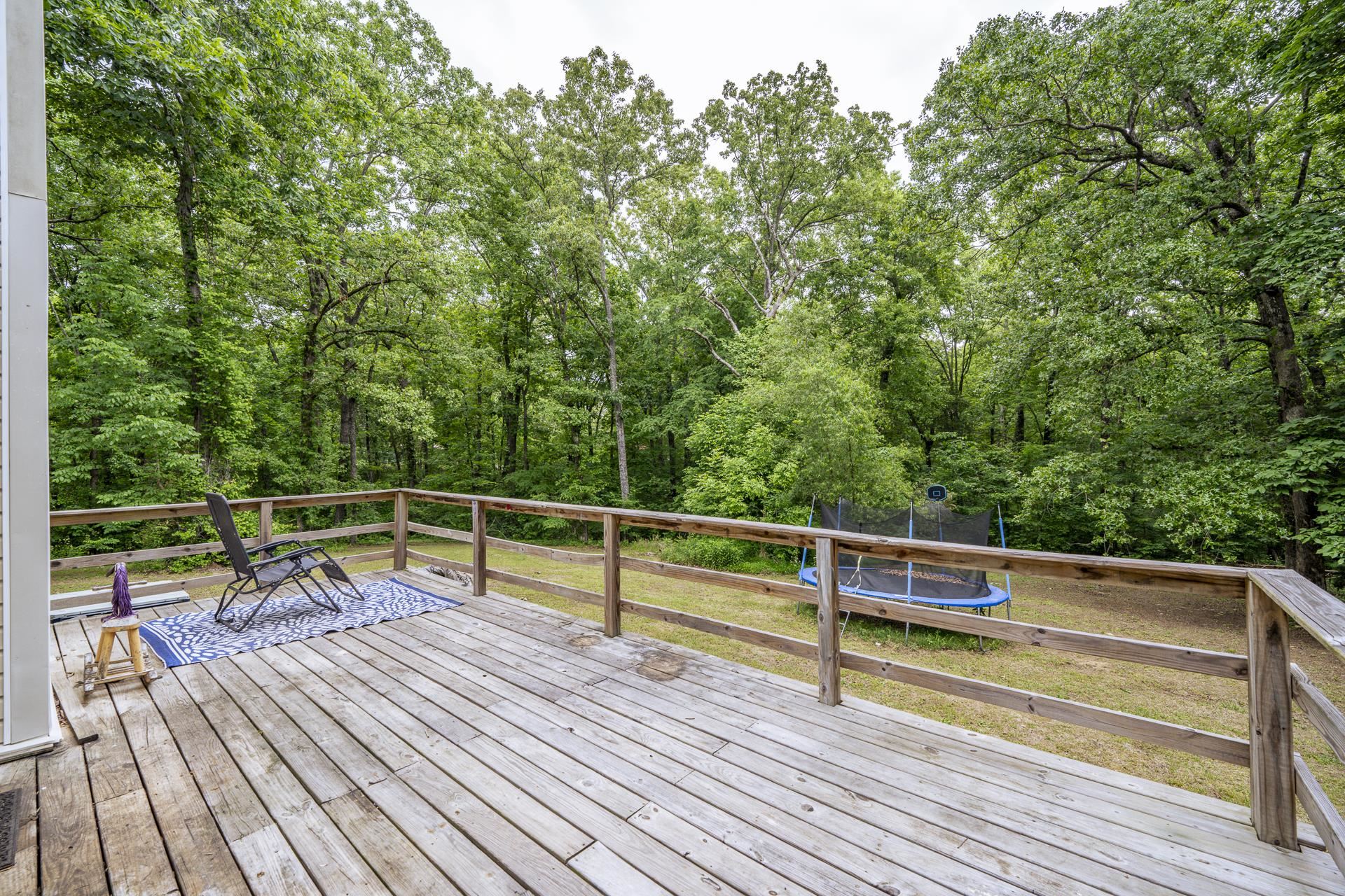 259 Oakview Drive Adamsville, TN 38310 - Photo 26 of 32 Spacious wood deck with a natural wood railing