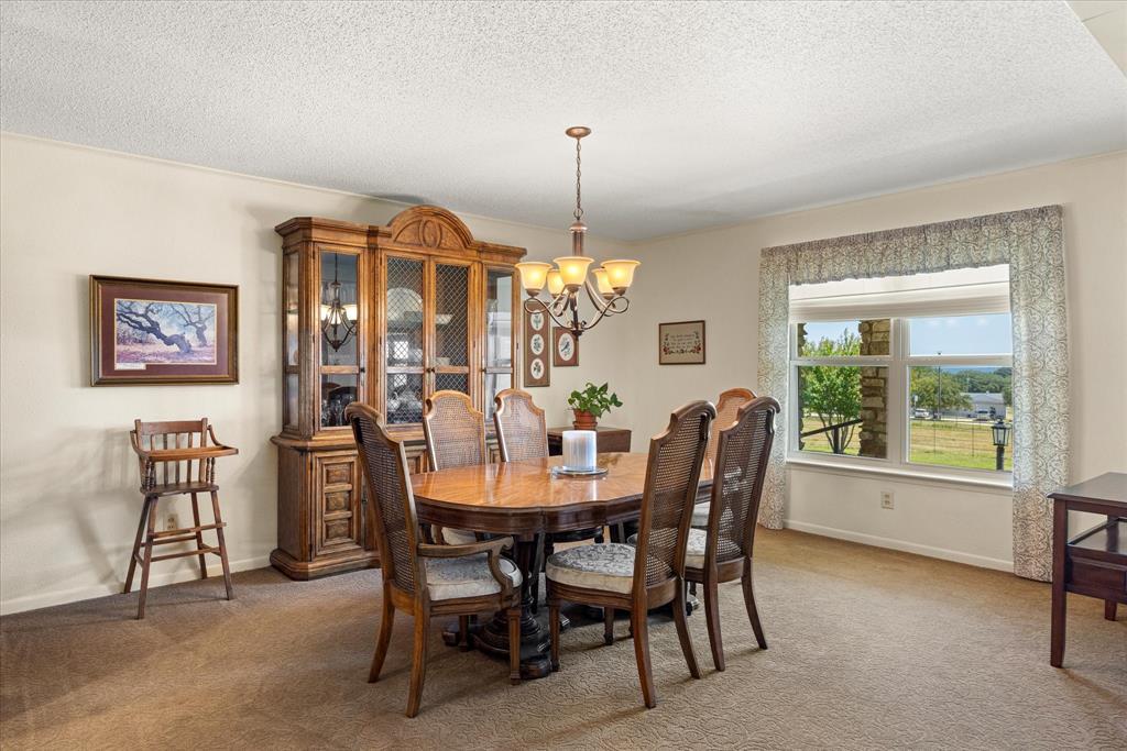 17305 Highway 281 Hico, TX 76457 - Photo 13 of 28 a dining room with furniture a chandelier and window