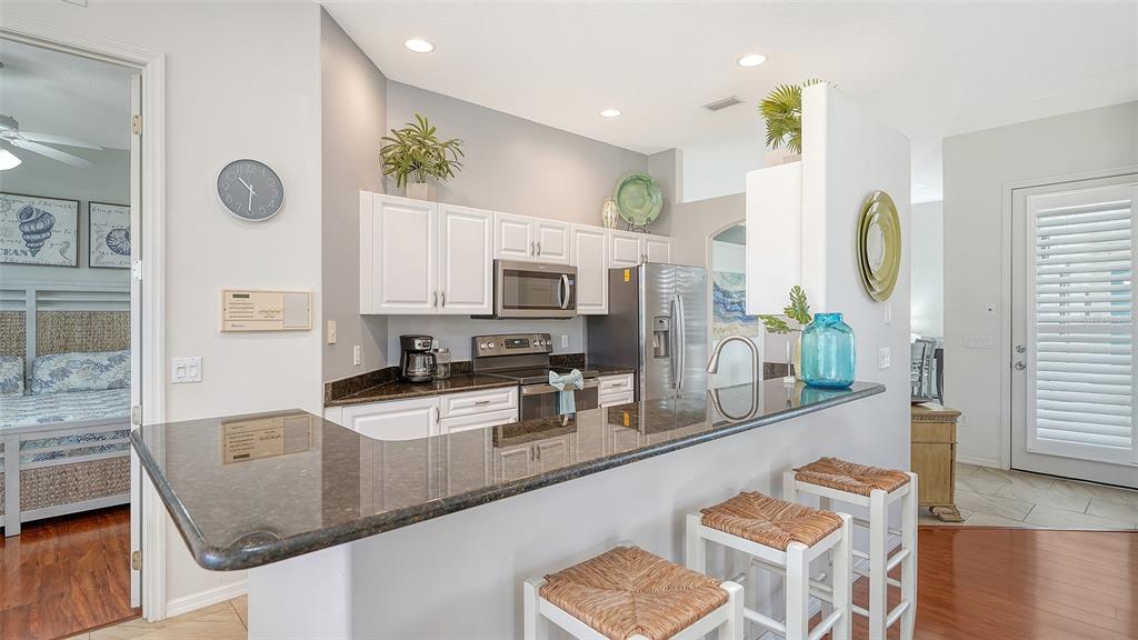 533 Fallbrook Drive Venice, FL 34292 - Photo 11 of 70 a kitchen with stainless steel appliances granite countertop a sink stove and cabinets