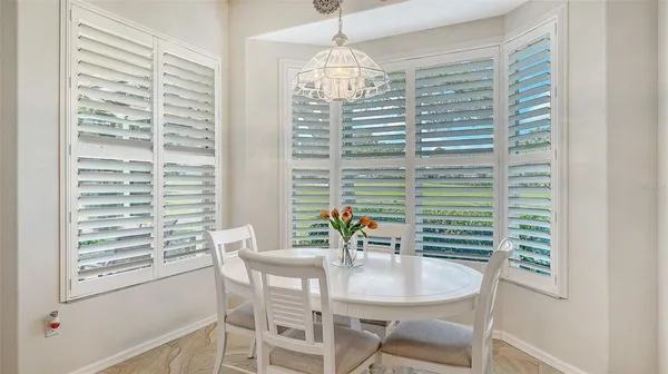 a view of a dining room with furniture and a window