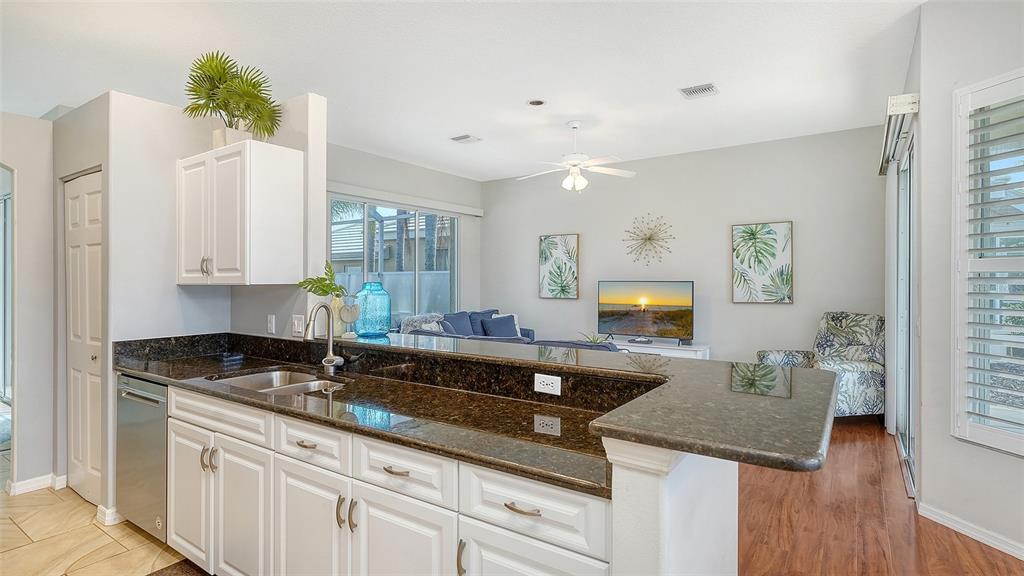 533 Fallbrook Drive Venice, FL 34292 - Photo 13 of 70 a kitchen with granite countertop a sink a stove and cabinets
