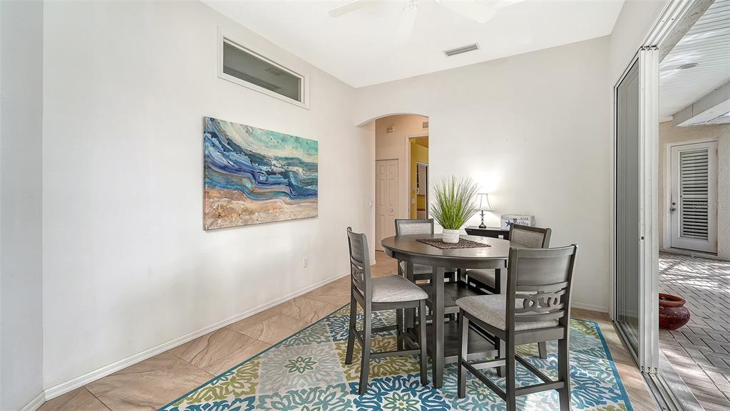 533 Fallbrook Drive Venice, FL 34292 - Photo 17 of 70 a view of a dining room with furniture and a window