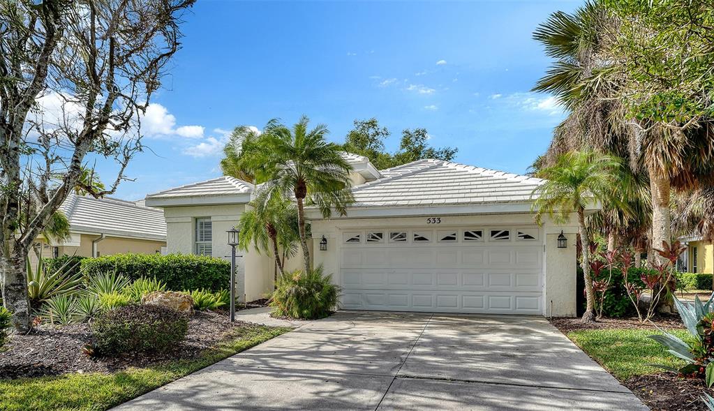 533 Fallbrook Drive Venice, FL 34292 - Photo 2 of 70 a front view of a house with a yard and a garage