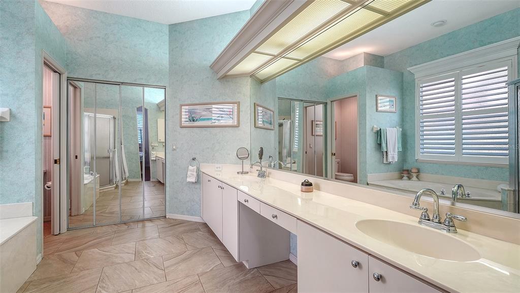 533 Fallbrook Drive Venice, FL 34292 - Photo 21 of 70 a spacious bathroom with a double vanity sink a large mirror and a shower
