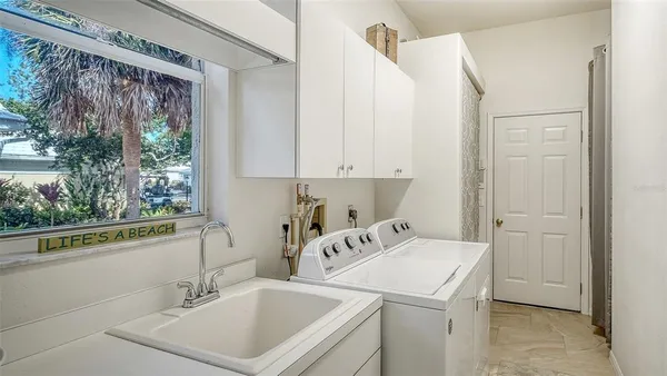 a view of a house with backyard sitting area and swimming pool