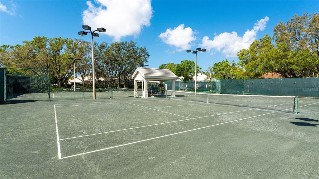 533 Fallbrook Drive Venice, FL 34292 - Photo 64 of 70 a view of a tennis ground with large trees