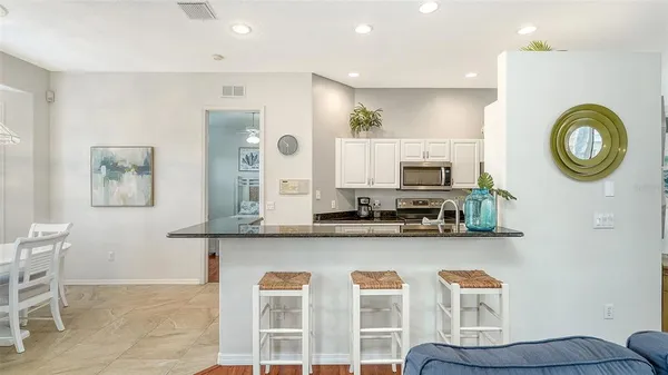 a kitchen with stainless steel appliances granite countertop a stove and a microwave