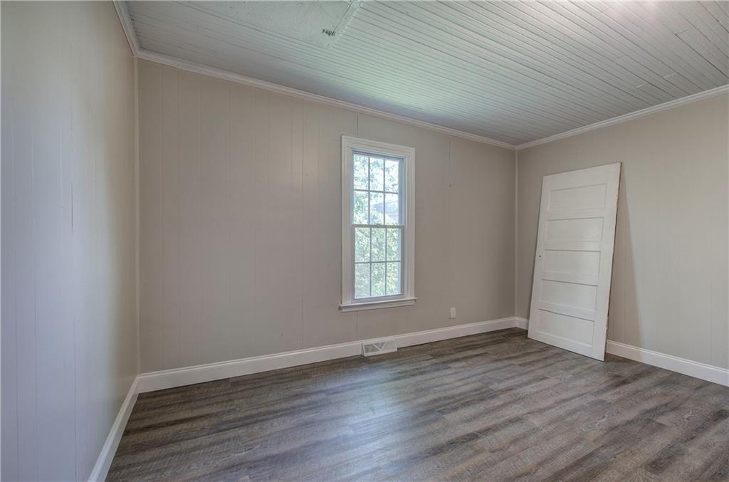 2014 Maple Avenue Southwest Rome, GA 30161 - Photo 12 of 22 an empty room with wooden floor and window