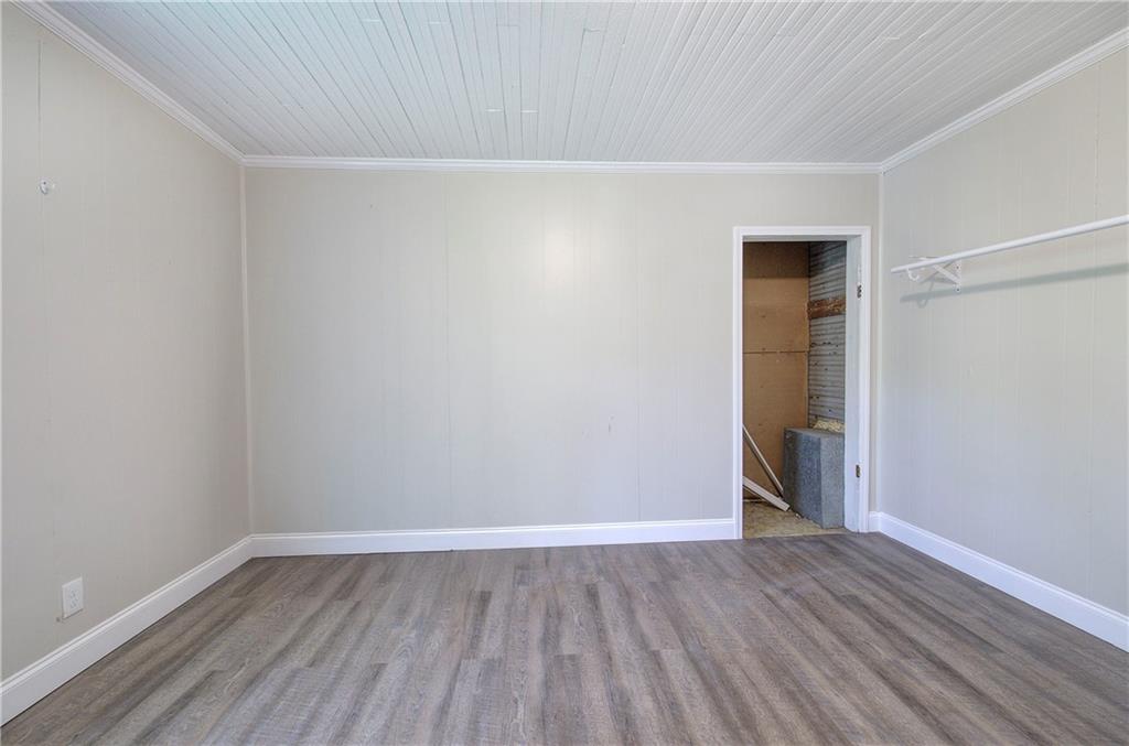 2014 Maple Avenue Southwest Rome, GA 30161 - Photo 13 of 22 a view of an empty room with wooden floor and closet