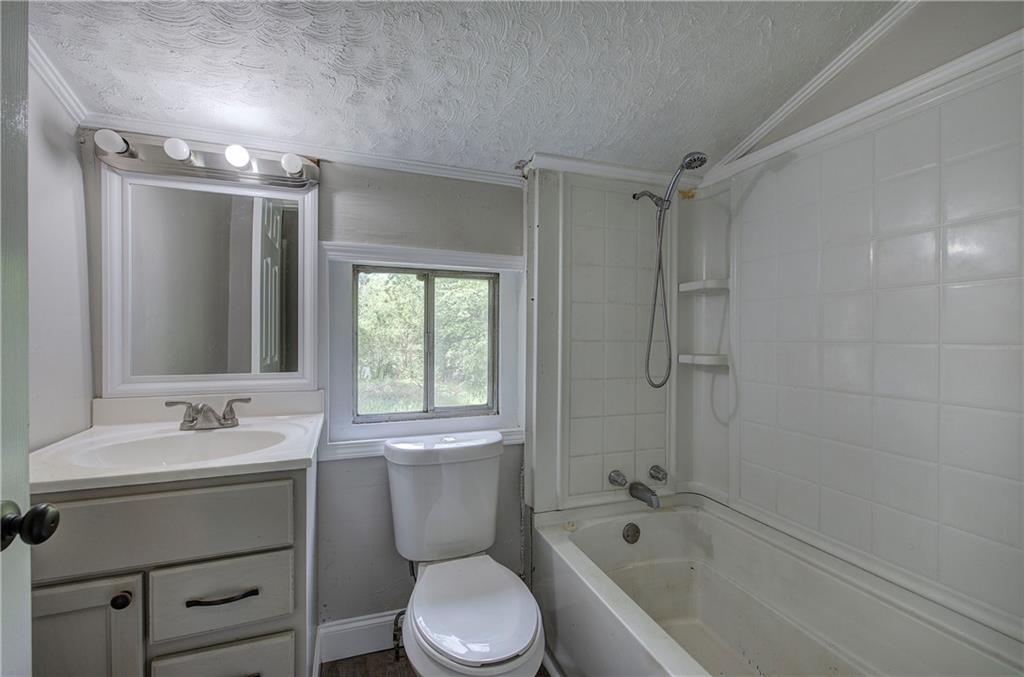 2014 Maple Avenue Southwest Rome, GA 30161 - Photo 15 of 22 a bathroom with a sink toilet and shower
