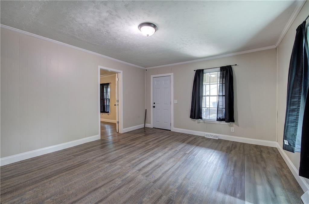 2014 Maple Avenue Southwest Rome, GA 30161 - Photo 4 of 22 an empty room with wooden floor and windows
