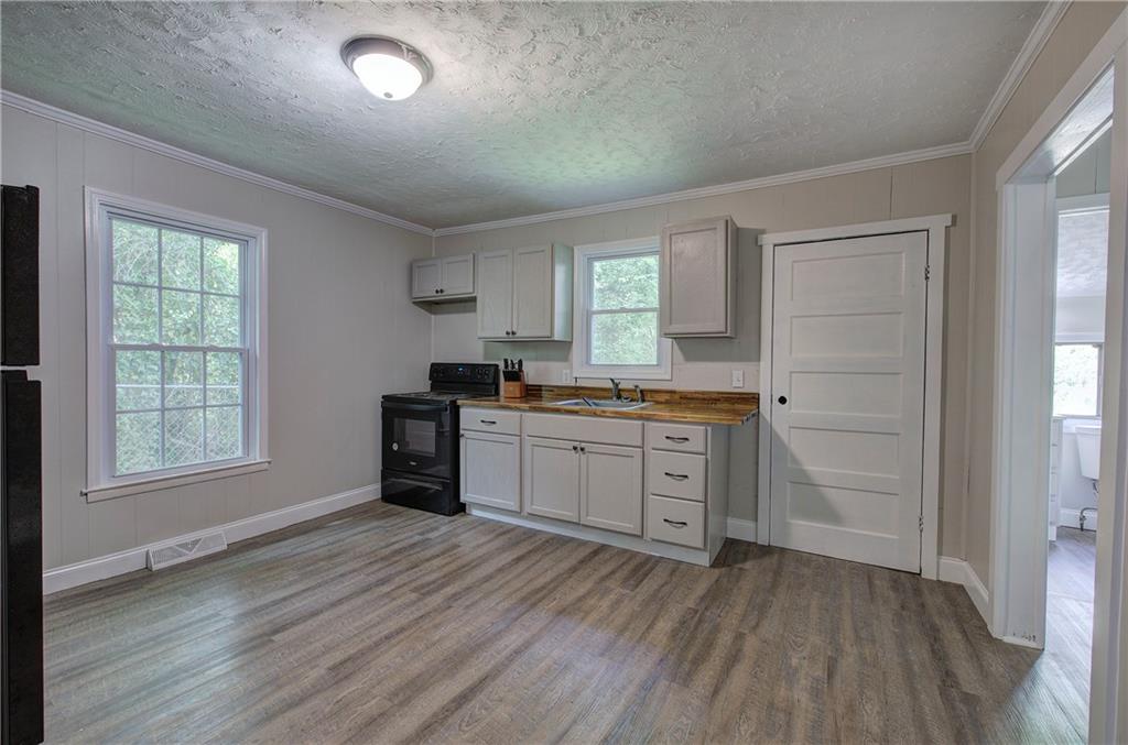 2014 Maple Avenue Southwest Rome, GA 30161 - Photo 8 of 22 a kitchen with a refrigerator and window