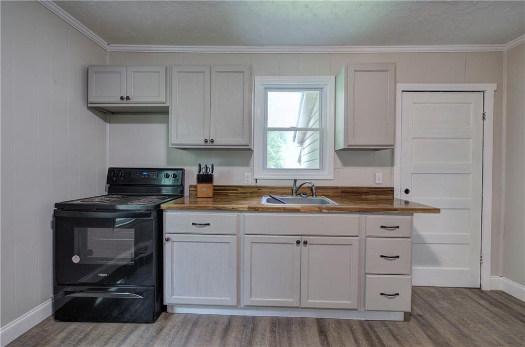 2014 Maple Avenue Southwest Rome, GA 30161 - Photo 10 of 22 a kitchen with stainless steel appliances granite countertop a stove a sink and a microwave
