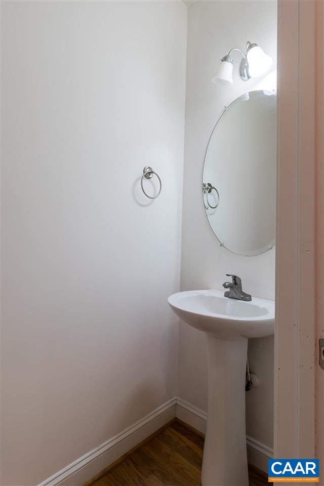 282 Lake Drive, Unit 2 Ruckersville, VA 22968 - Photo 11 of 27 a bathroom with a sink a mirror and vanity