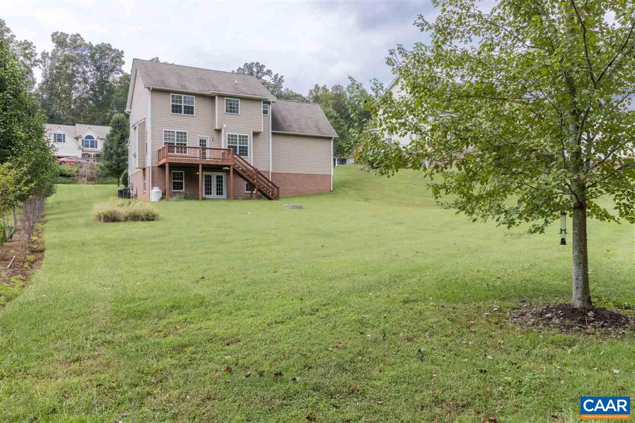 282 Lake Drive, Unit 2 Ruckersville, VA 22968 - Photo 24 of 27 a view of a house with a yard