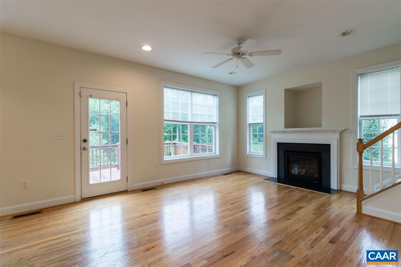 282 Lake Drive, Unit 2 Ruckersville, VA 22968 - Photo 4 of 27 a view of an empty room with wooden floor fireplace and a window