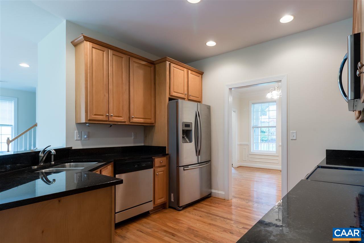 282 Lake Drive, Unit 2 Ruckersville, VA 22968 - Photo 6 of 27 a kitchen with stainless steel appliances granite countertop a refrigerator a sink and white cabinets