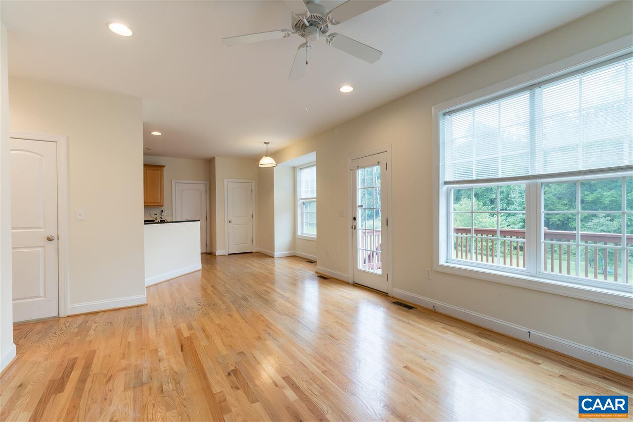 282 Lake Drive, Unit 2 Ruckersville, VA 22968 - Photo 7 of 27 a view of an empty room with a window and wooden floor