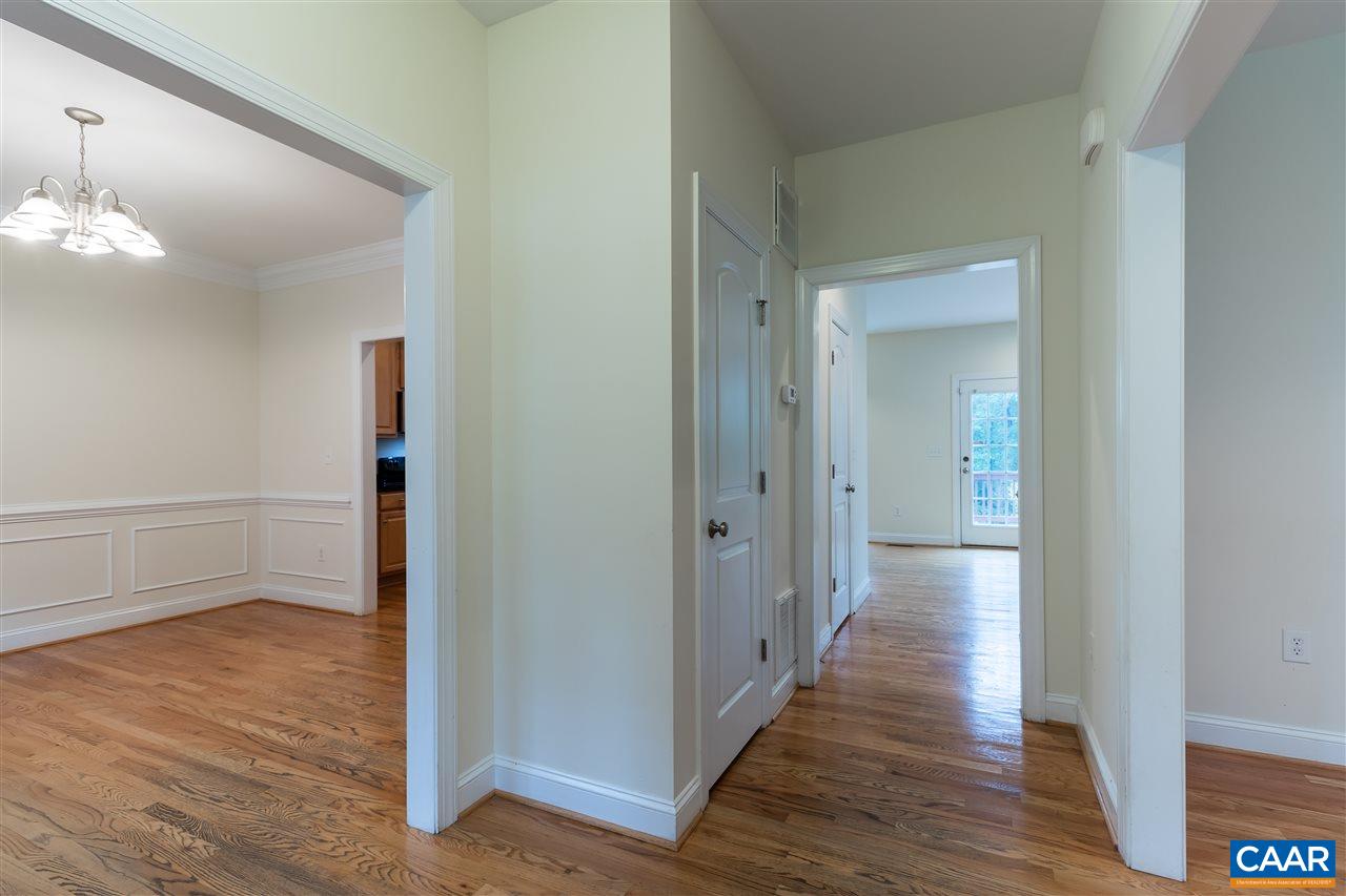 282 Lake Drive, Unit 2 Ruckersville, VA 22968 - Photo 9 of 27 a view of a hallway with wooden floor and staircase
